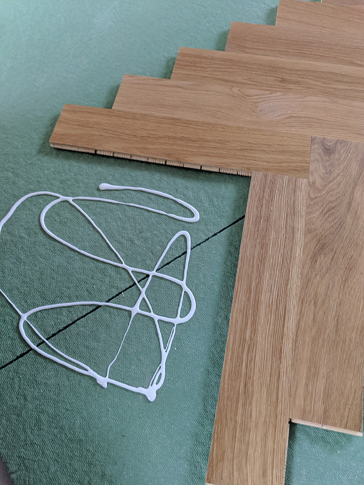 How to lay parquet flooring - gluing centre row